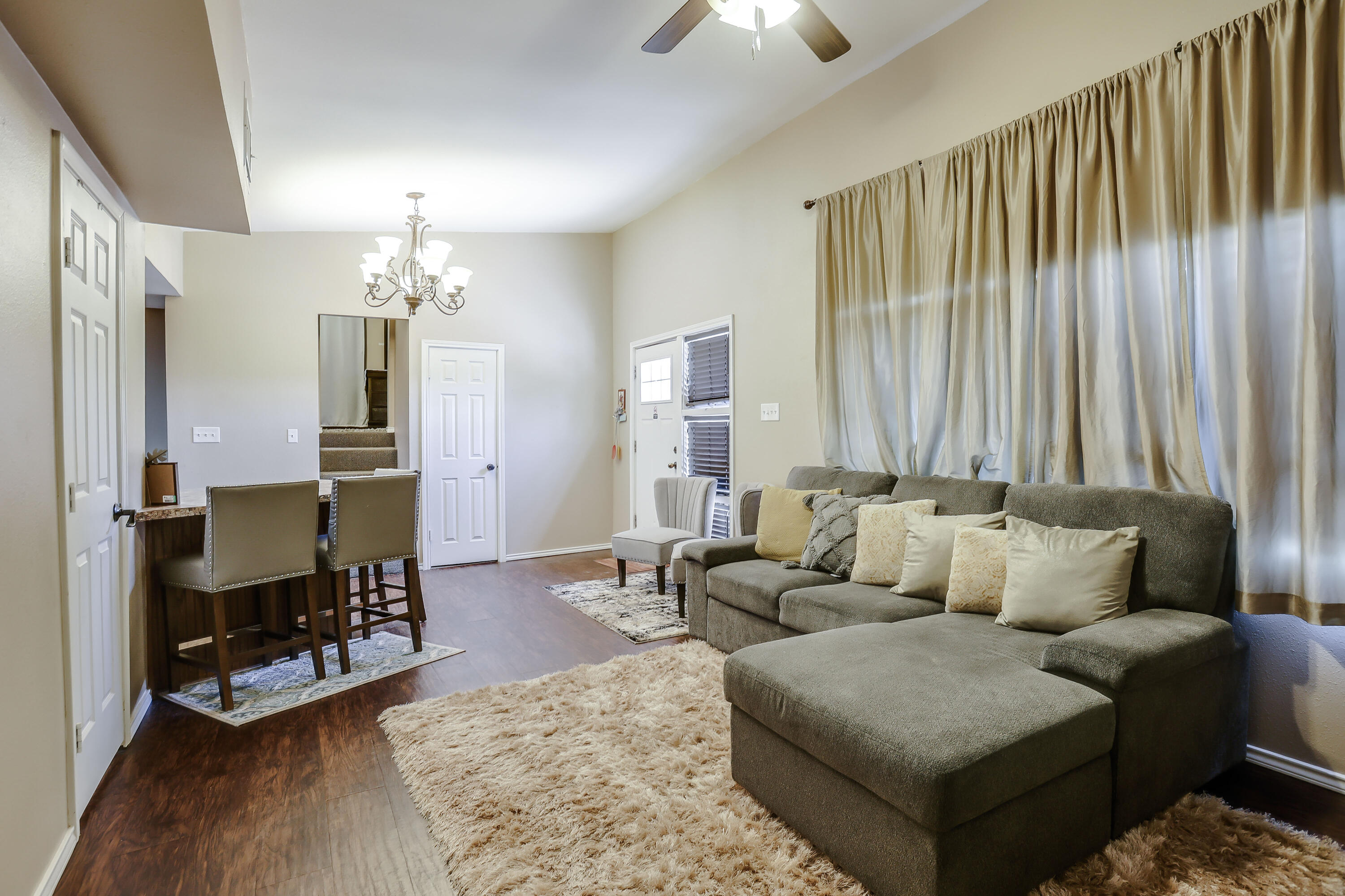 68 Pony Express Trail Lubbock, TX 79404 - Photo 6 of 15 a living room with furniture and a chandelier