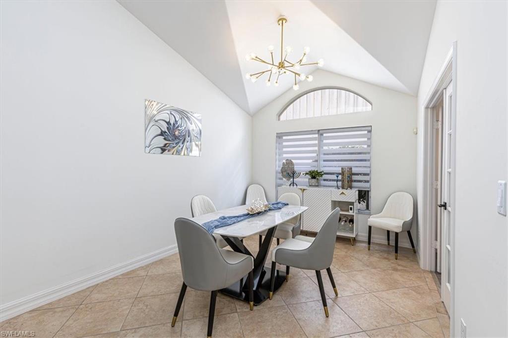 1630 Triangle Palm Terrace Naples, FL 34119 - Photo 11 of 24 a view of a dining room with furniture and a chandelier