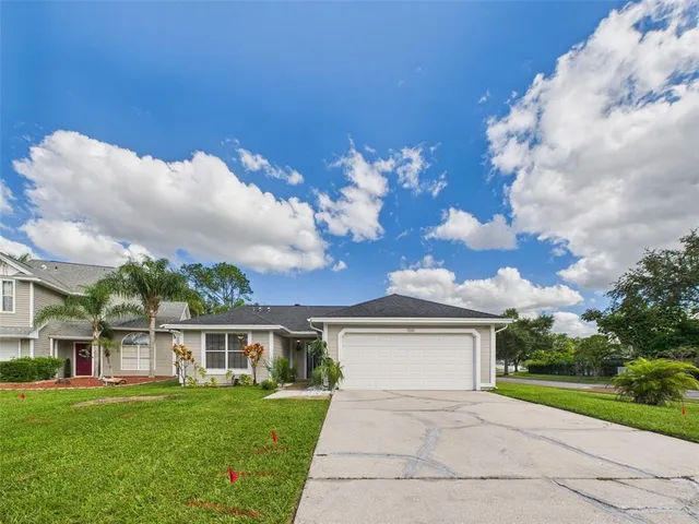 a view of a house with a yard and sitting area