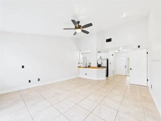 a view of a kitchen with furniture and a ceiling fan