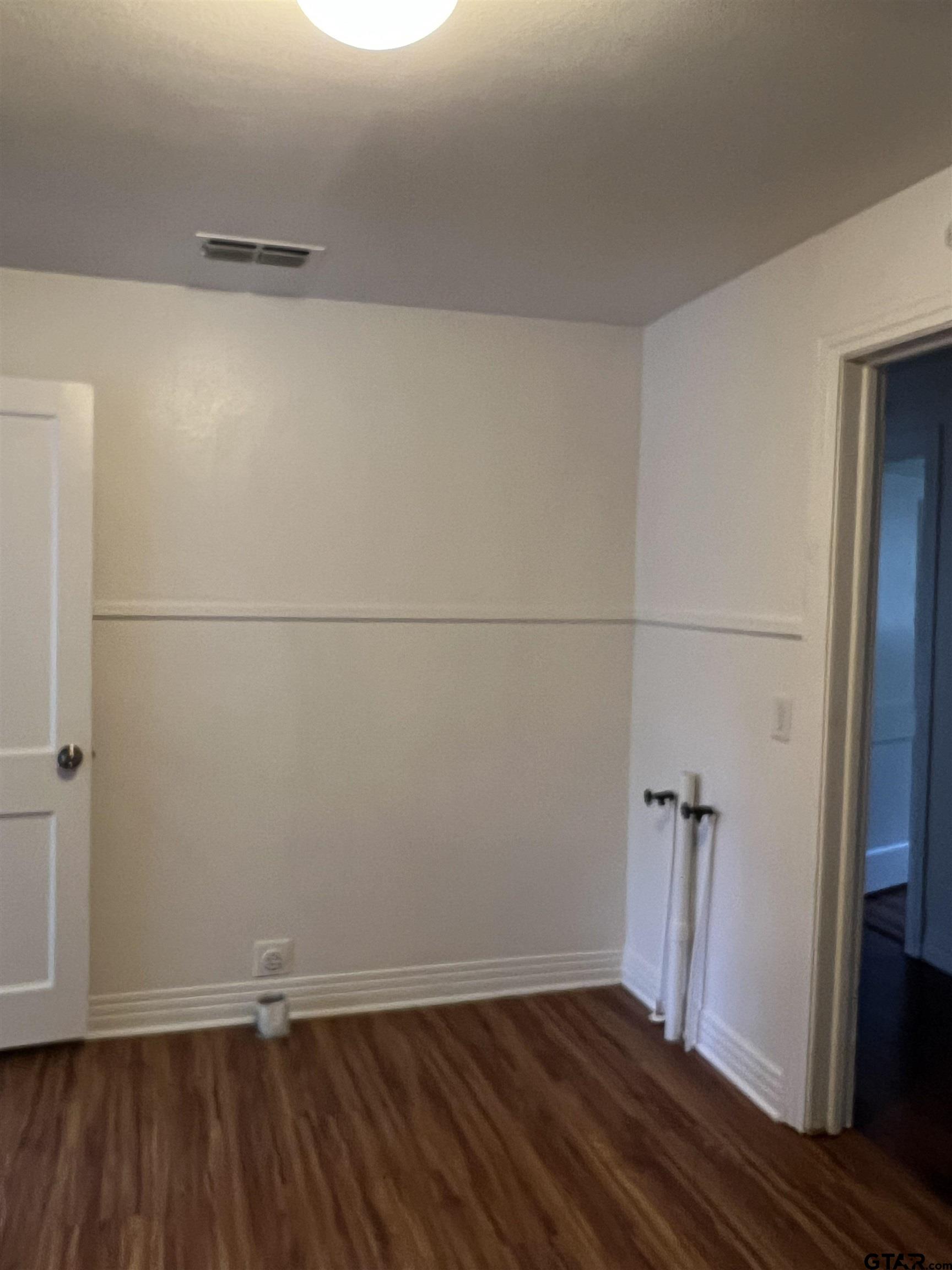 902 West 5th Street Tyler, TX 75701 - Photo 5 of 11 a view of small space with wooden floor