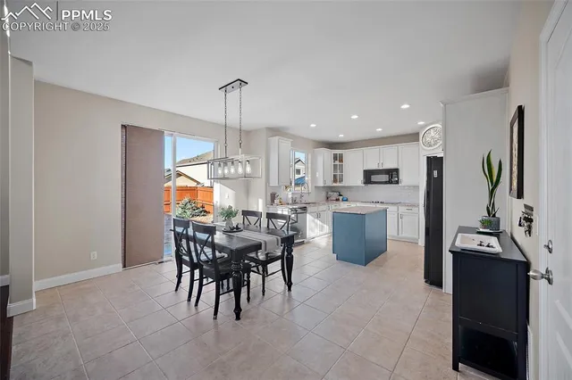 a kitchen with a table and chairs in it