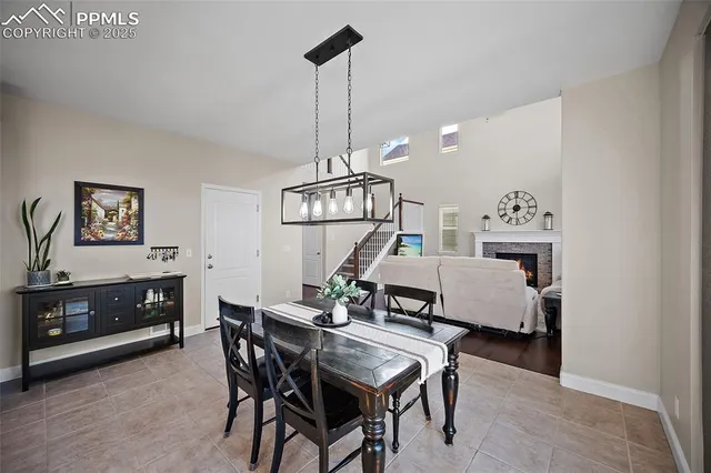a view of a livingroom with furniture a chandelier and wooden floor