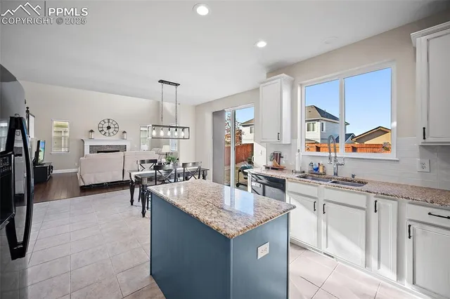 a kitchen with living room and cabinets