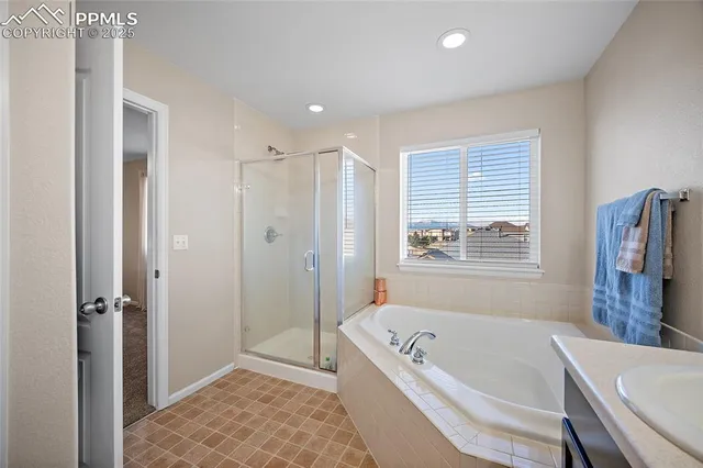 a bathroom with a double vanity sink mirror and bathtub