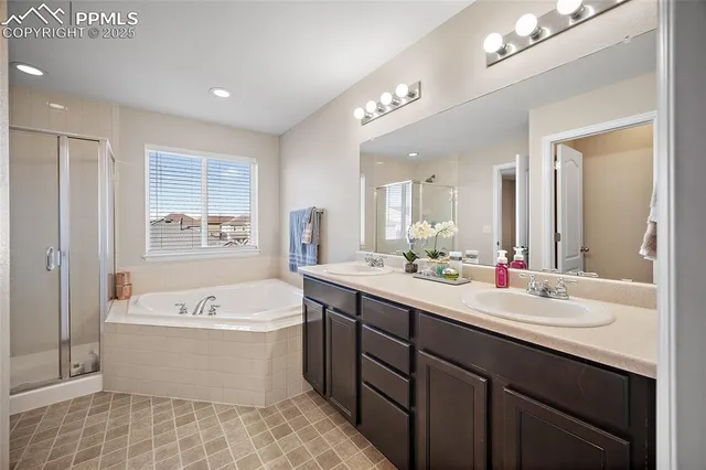 a view of walk in closet with clothes