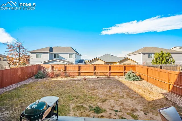 a view of a house with backyard and sitting area