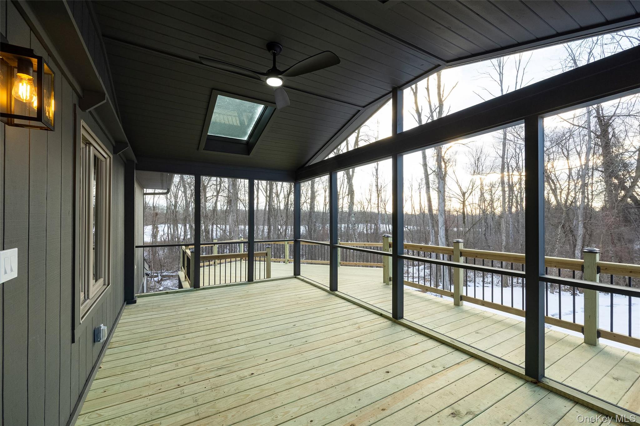 261 Freedom Road Pleasant Valley, NY 12569 - Photo 36 of 50 Unfurnished sunroom featuring a deck, ceiling fan, vaulted ceiling, and a skylight