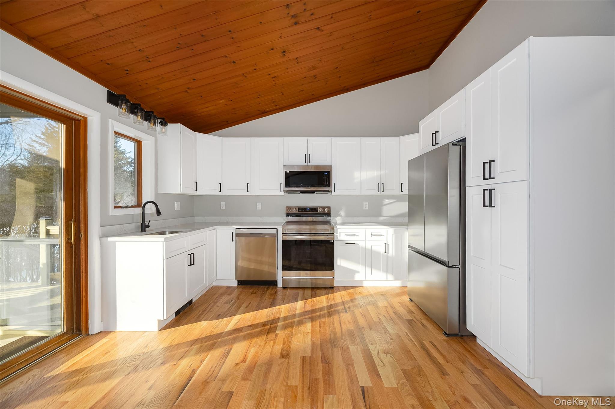 261 Freedom Road Pleasant Valley, NY 12569 - Photo 8 of 50 Kitchen featuring appliances with stainless steel finishes, white cabinetry, lofted ceiling, light wood-style flooring, and wood ceiling