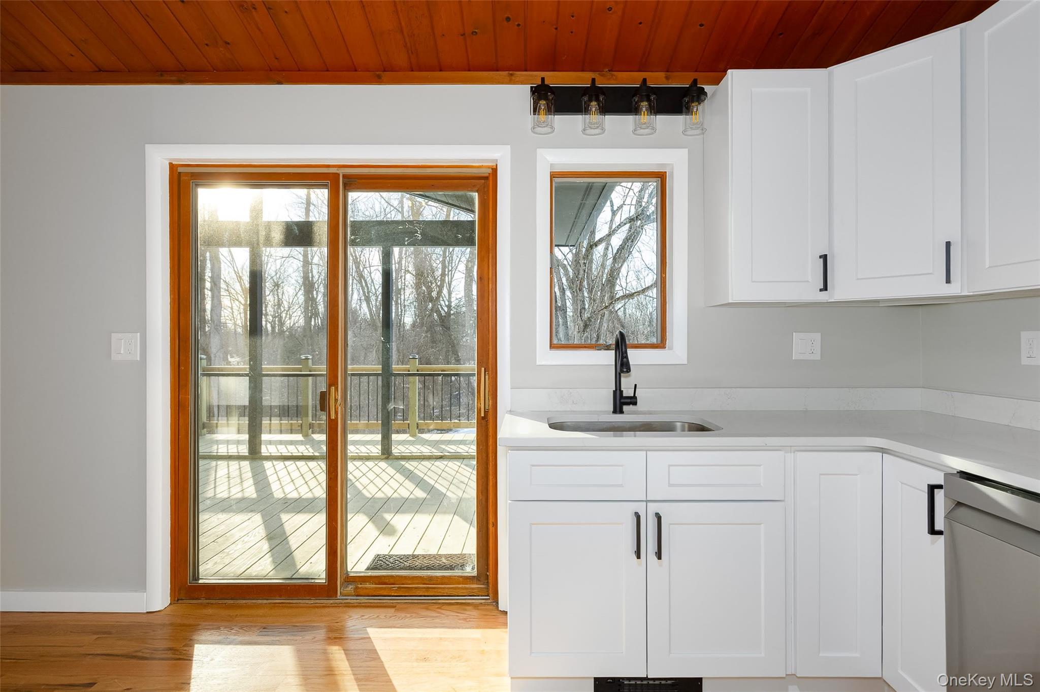261 Freedom Road Pleasant Valley, NY 12569 - Photo 10 of 50 Kitchen with white cabinetry, light stone countertops, stainless steel dishwasher, and wooden ceiling