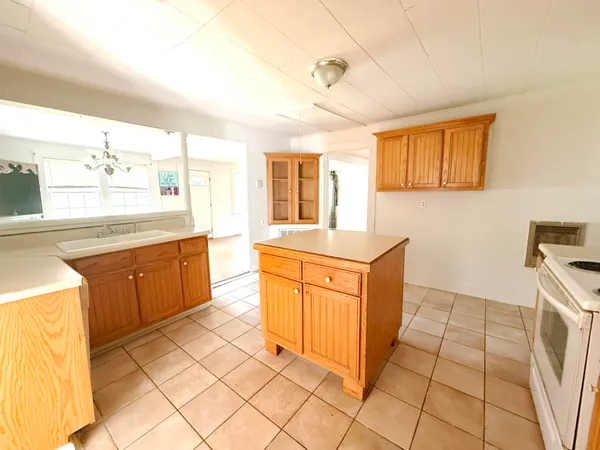 a large kitchen with stainless steel appliances granite countertop a sink and cabinets