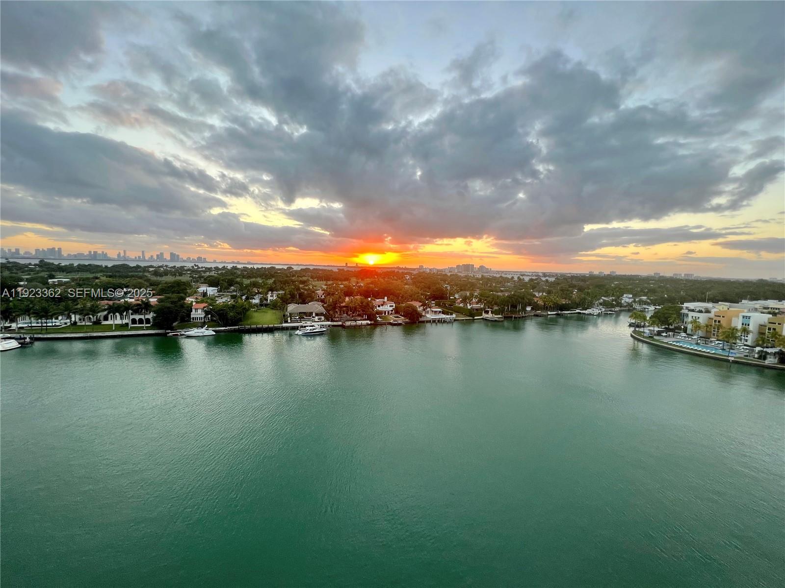 5838 Collins Avenue, Unit 8B Miami Beach, FL 33140 - Photo 1 of 30 a view of a lake and mountain in the back