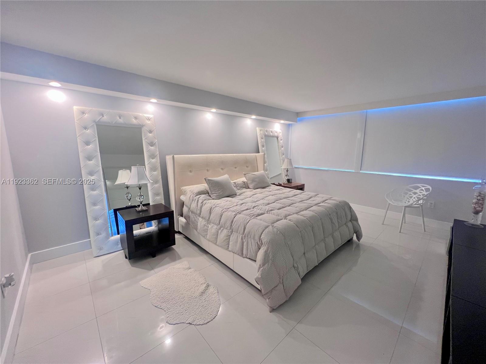 5838 Collins Avenue, Unit 8B Miami Beach, FL 33140 - Photo 12 of 30 a bedroom with a bed and a view of bathroom