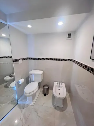a bathroom with a toilet a sink and a shower