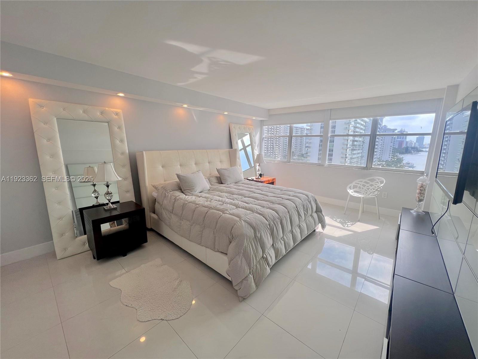 5838 Collins Avenue, Unit 8B Miami Beach, FL 33140 - Photo 17 of 30 a bed room with a bed and a couch