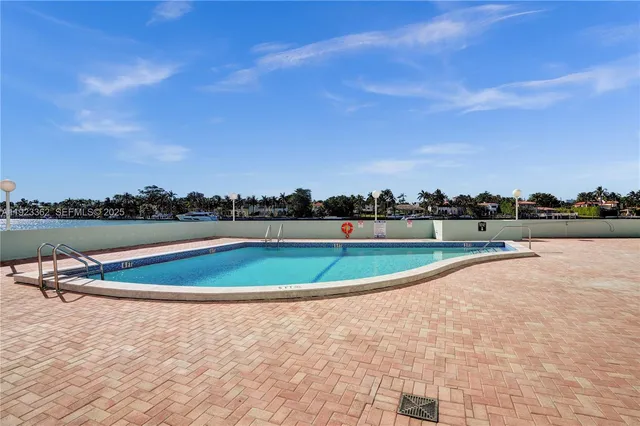 a view of a swimming pool and a yard