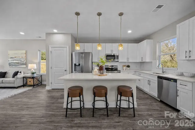 a front view of a house with yard and parking space