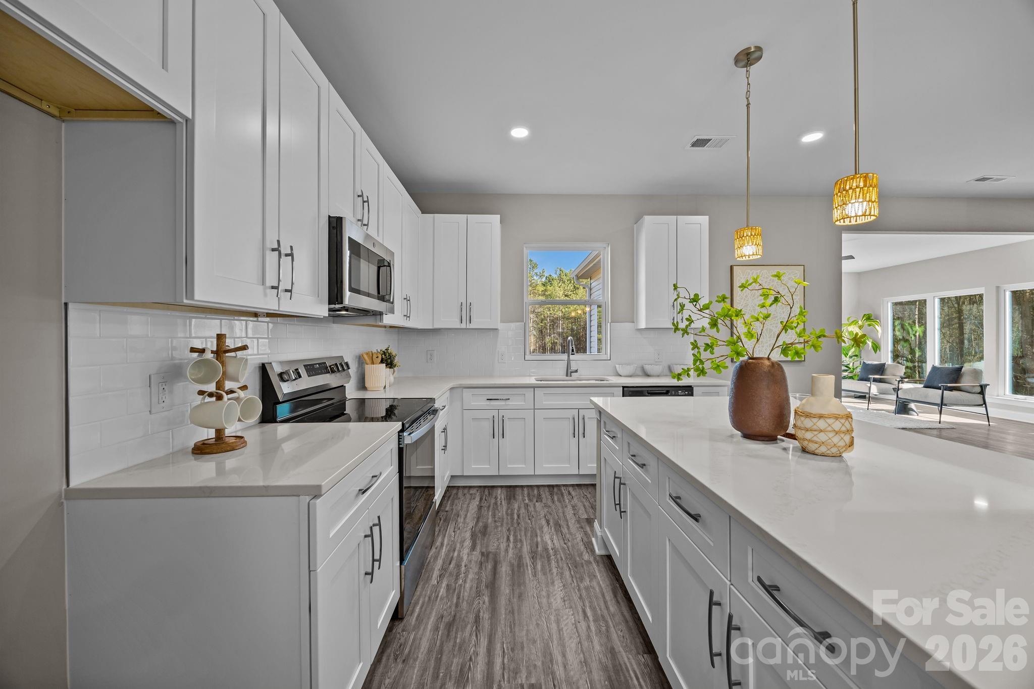 1813 Shuford Road Lincolnton, NC 28092 - Photo 14 of 47 a kitchen with a sink stove and cabinets