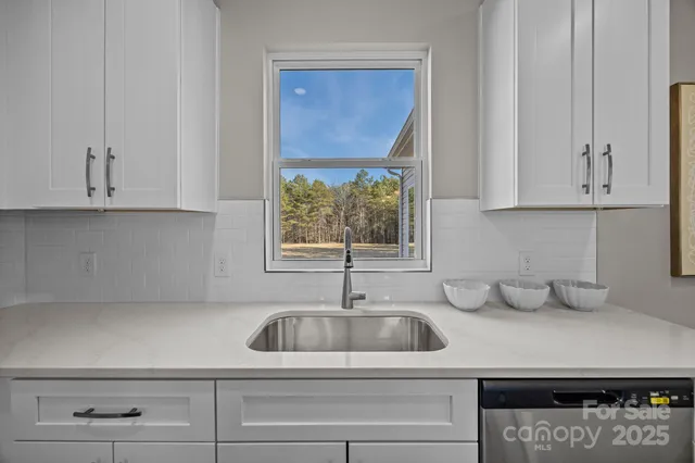 a kitchen with appliances cabinets and a window