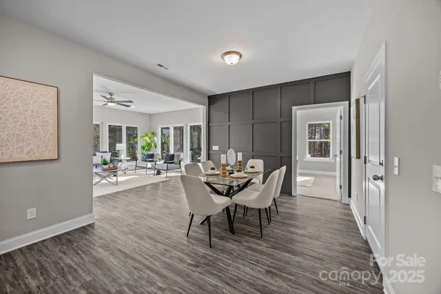 a dining room with furniture and wooden floor