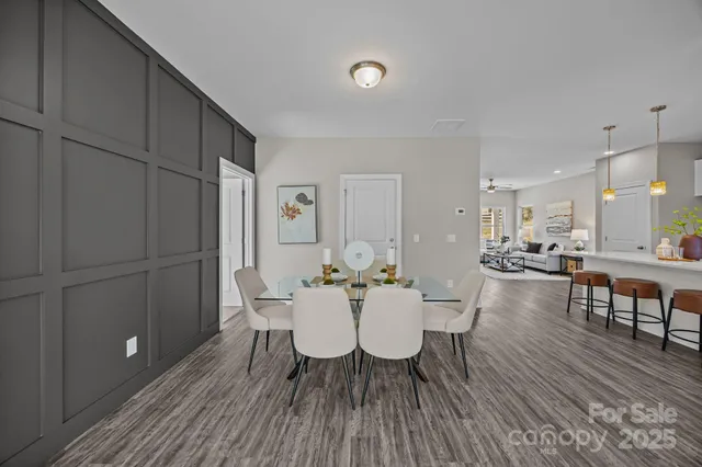 a view of a dining room with furniture and wooden floor