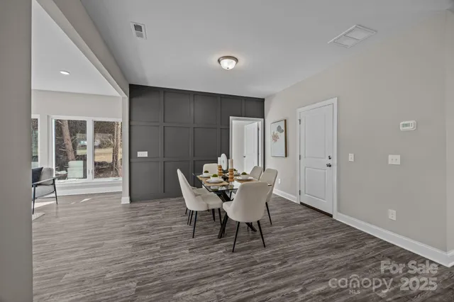 a dining room with furniture and wooden floor