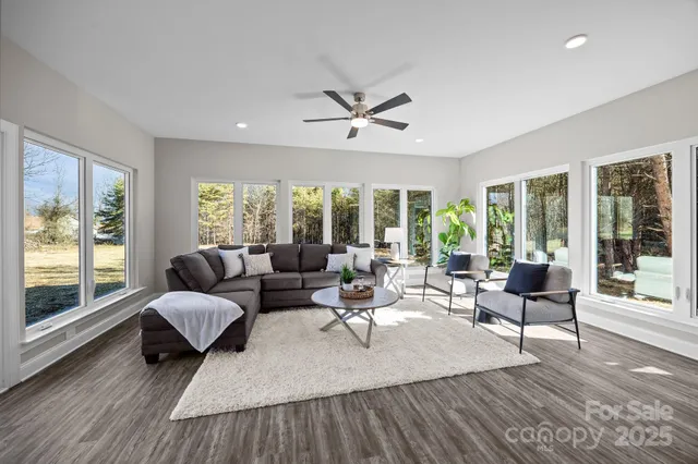 a living room with furniture and large windows