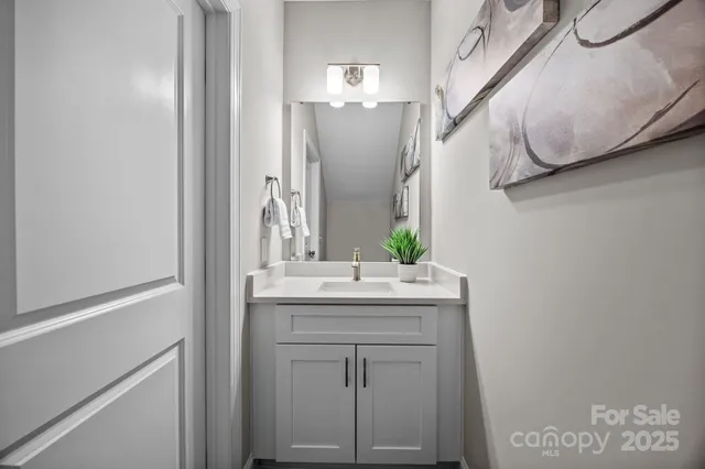a bathroom with a sink vanity and mirror