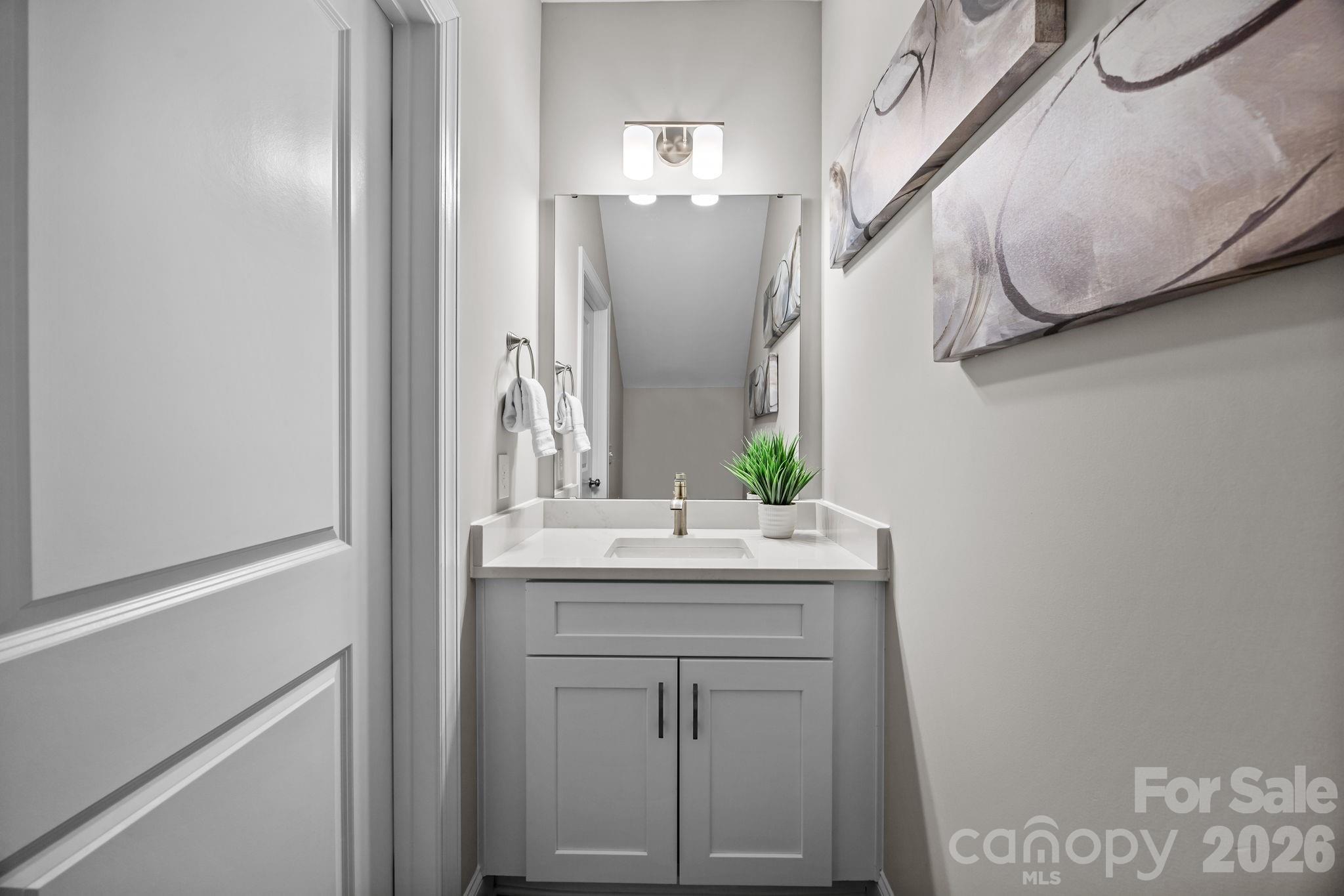 1813 Shuford Road Lincolnton, NC 28092 - Photo 10 of 47 a bathroom with a sink vanity and mirror