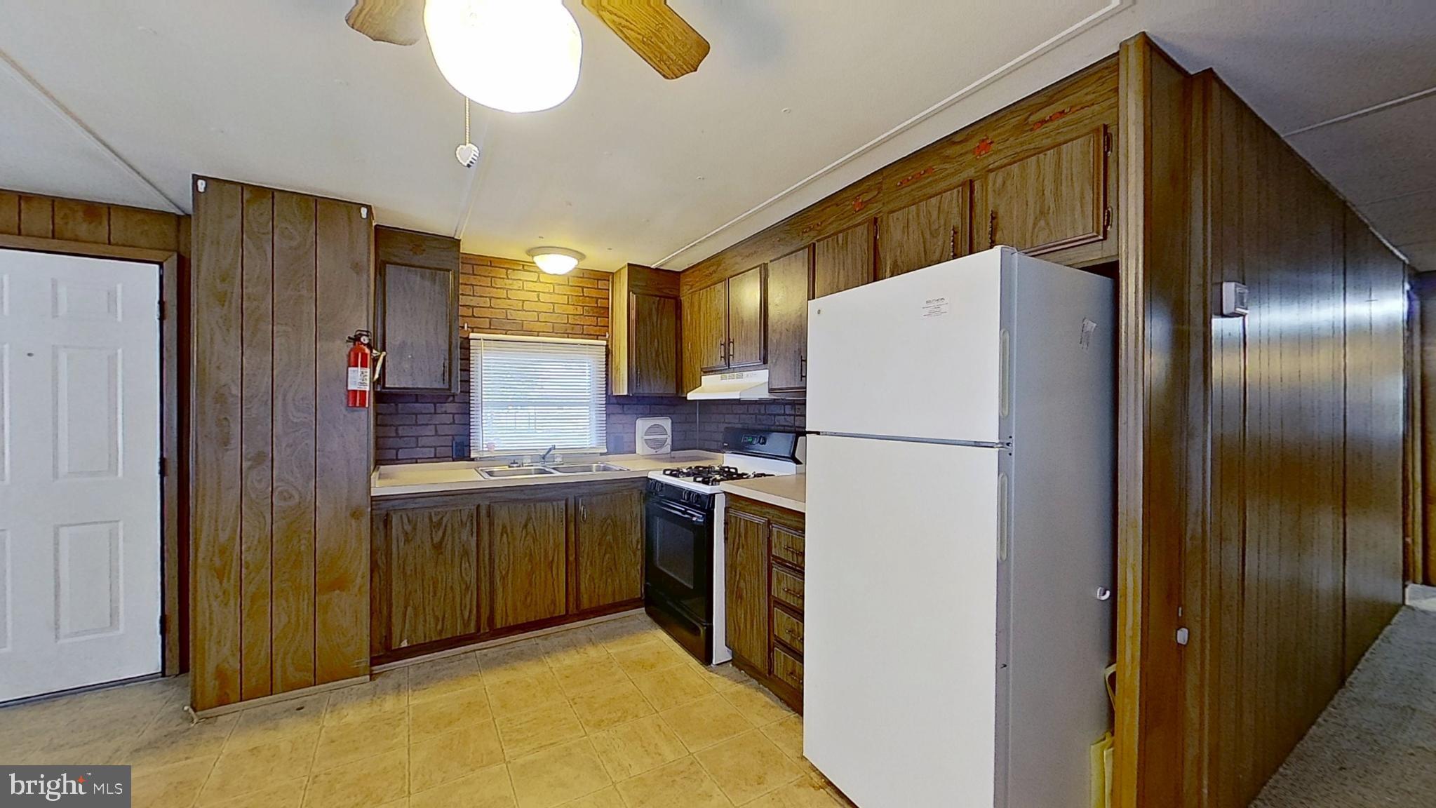 3230 Oakland Road, Unit 1 Dover, PA 17315 - Photo 4 of 5 a kitchen with stainless steel appliances granite countertop a refrigerator and a sink