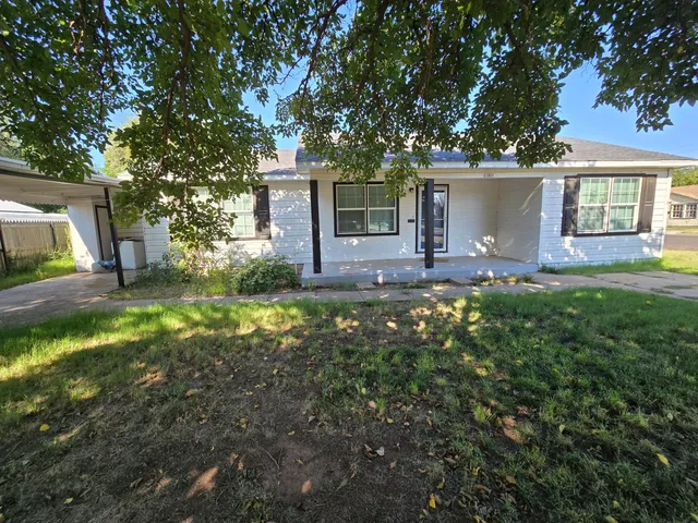 a house view with a sitting space and garden