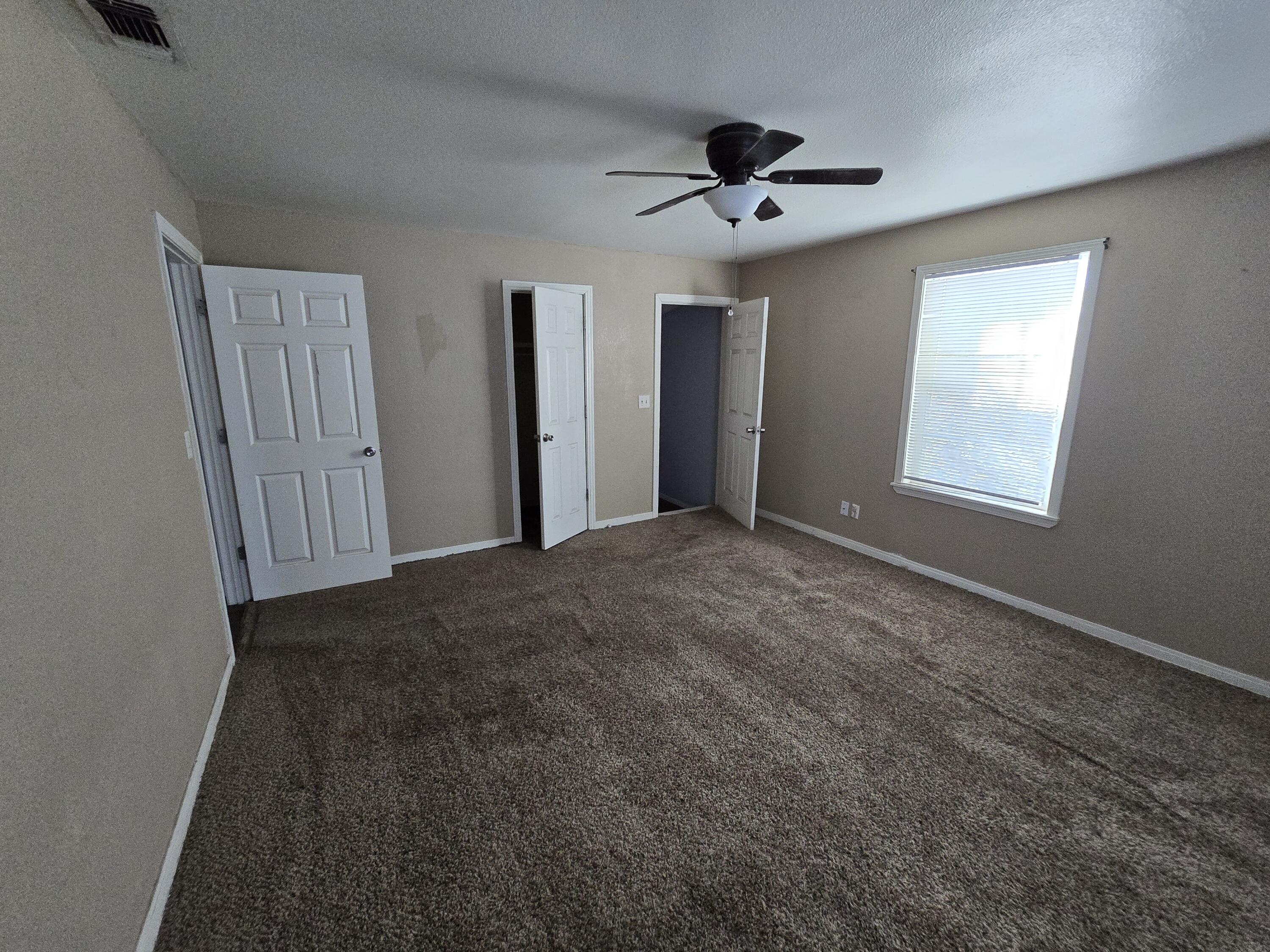 1011 Wayland Plainview, TX 79072 - Photo 13 of 14 a view of an empty room with a ceiling fan