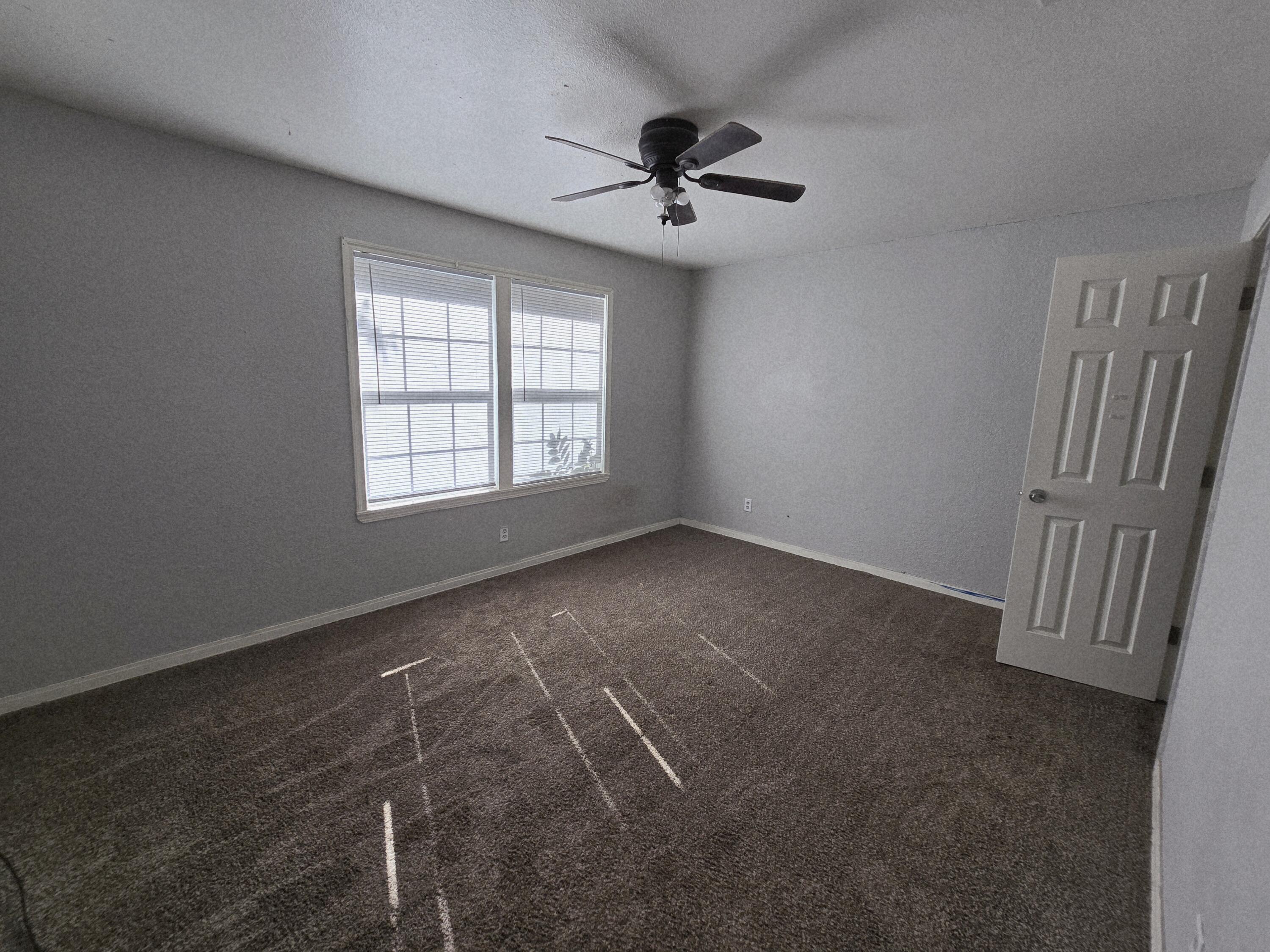 1011 Wayland Plainview, TX 79072 - Photo 8 of 14 a view of an empty room with a window
