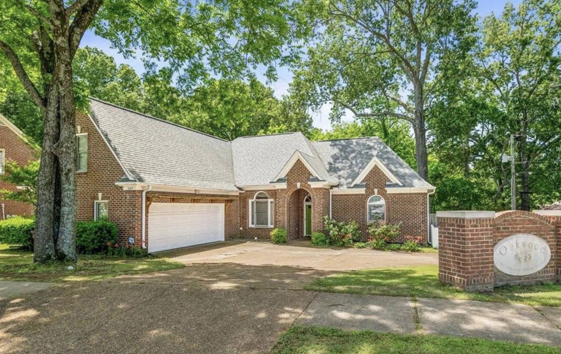 285 Great Falls Road Collierville, TN 38017 - Photo 1 of 29 Brick exterior with a gabled roofline, arched entry, and white garage door