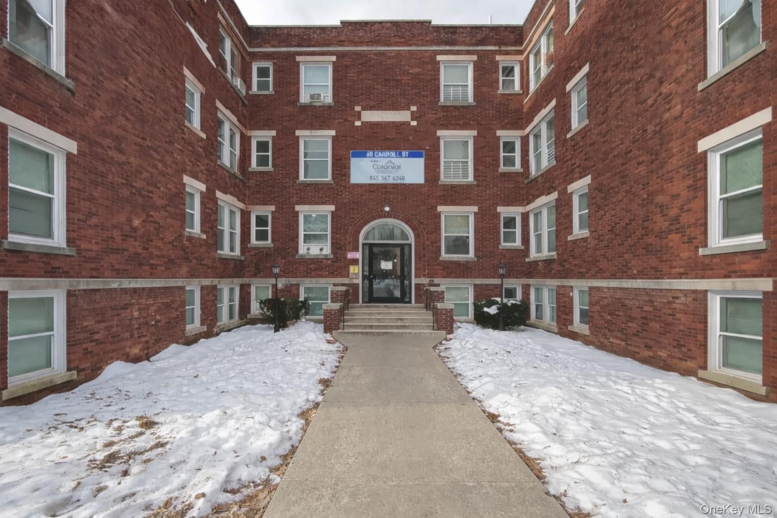 60 Carroll Street, Unit C3 Poughkeepsie, NY 12601 - Photo 1 of 19 a view of a building with a yard