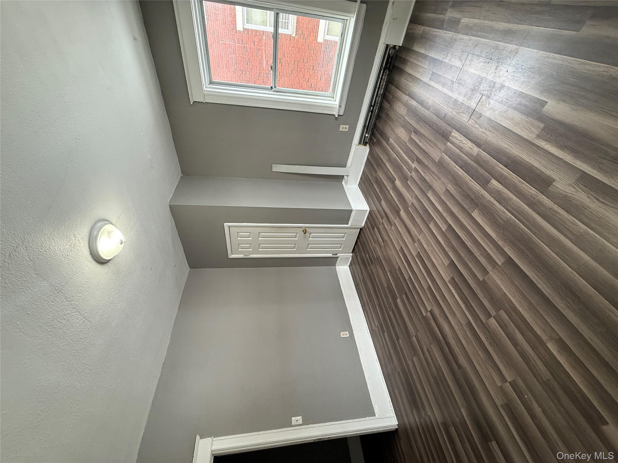 60 Carroll Street, Unit C3 Poughkeepsie, NY 12601 - Photo 5 of 19 an empty room with wooden floor and windows