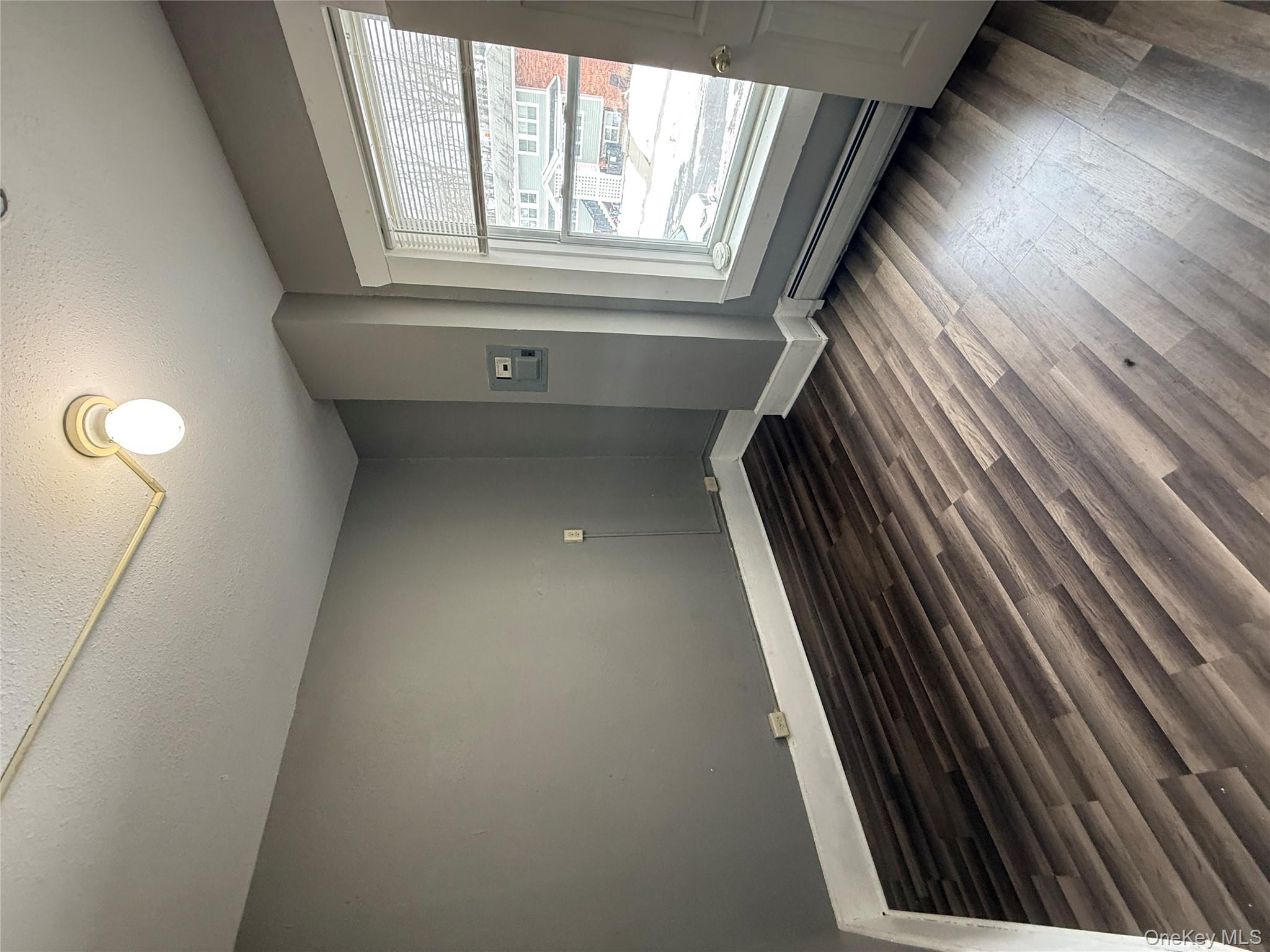 60 Carroll Street, Unit C3 Poughkeepsie, NY 12601 - Photo 7 of 19 an empty room with wooden floor and windows