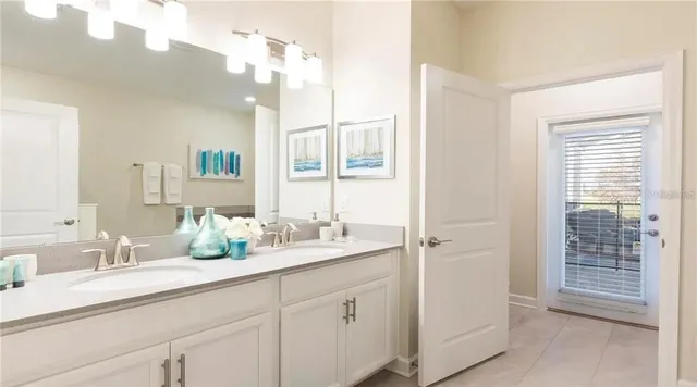 a bathroom with a sink double vanity granite and a mirror