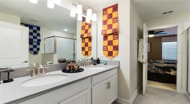 a bathroom with double vanity and a bathtub