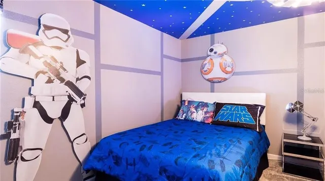 a bedroom with a bed and a chandelier