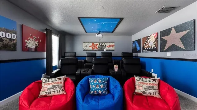 a living room with furniture and painting on the wall