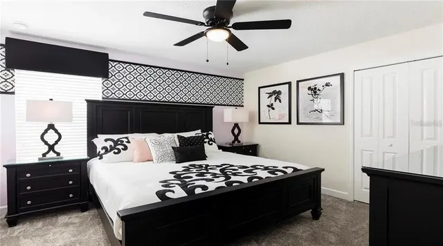 a living room with a couch and a ceiling fan