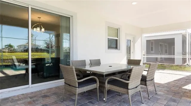 a view of a dining room with furniture and window