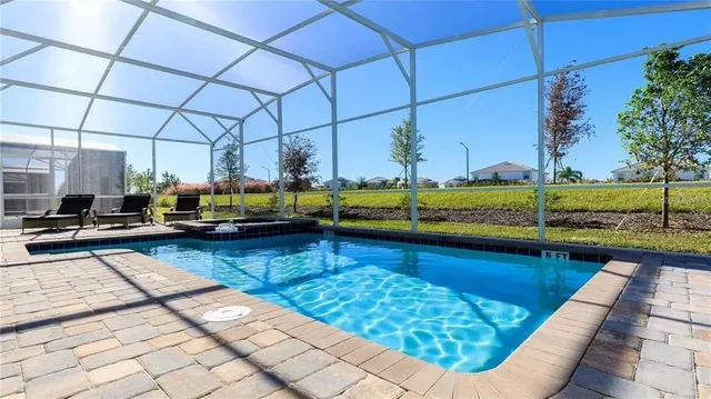 a view of a swimming pool with a lounge chairs