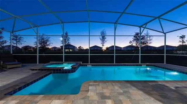 a view of a backyard with swimming pool