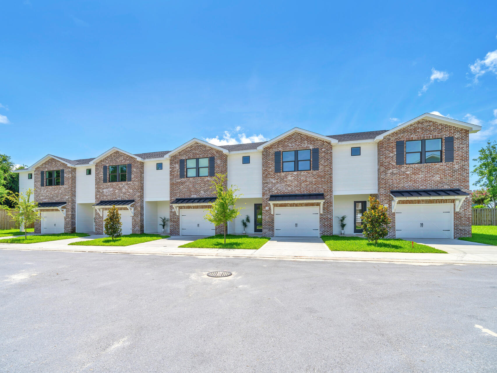 140 Sibert Avenue, Unit 11 Destin, FL 32541 - Photo 29 of 38 a view of a building with a big yard and large trees