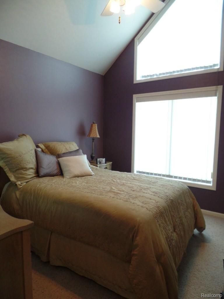 6340 Vassar Road Grand Blanc, MI 48439 - Photo 30 of 51 The 1st floor bedroom #2 offers a vaulted ceiling and ample windows for natural ambient lighting.