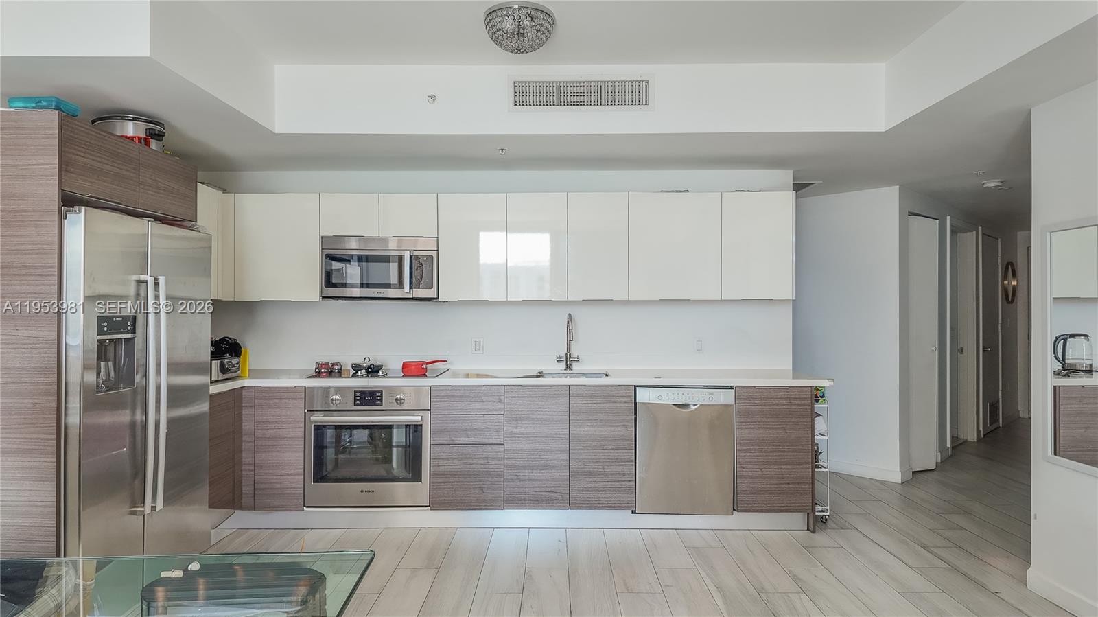 1010 Southwest 2nd Avenue, Unit 1209 Miami, FL 33130 - Photo 2 of 11 a kitchen with stainless steel appliances granite countertop a stove a sink dishwasher and a refrigerator with wooden floor