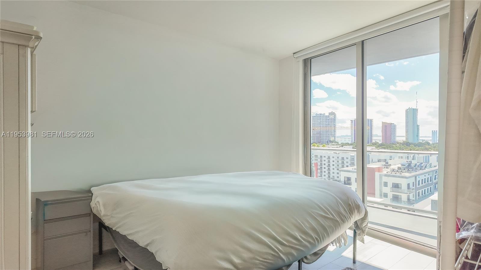 1010 Southwest 2nd Avenue, Unit 1209 Miami, FL 33130 - Photo 4 of 11 a bedroom with a bed and a large window
