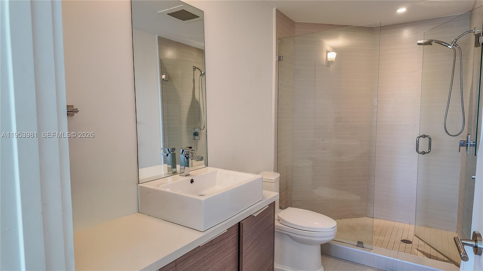 1010 Southwest 2nd Avenue, Unit 1209 Miami, FL 33130 - Photo 6 of 11 a bathroom with a sink a toilet and shower